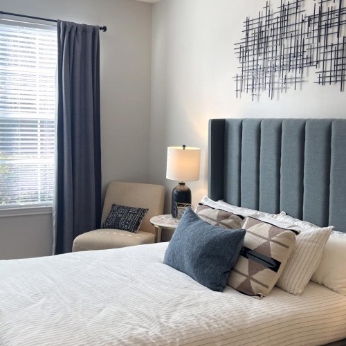 a bedroom with a bed and a chair