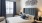 a bedroom with a bed and a chair