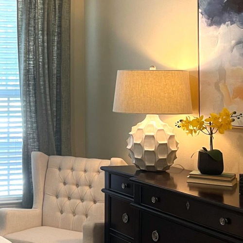 a room with a lamp and a chair