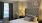 a bedroom with a bed and a fan