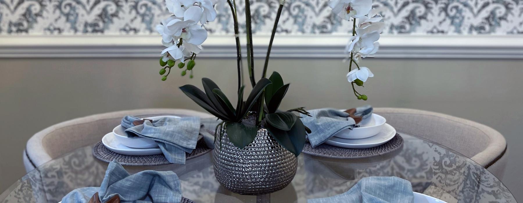 a vase with white flowers on a table